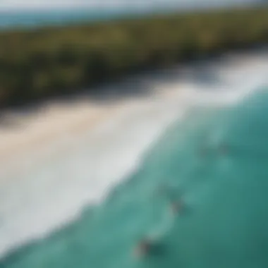 An aerial view showcasing kiteboarders gliding over turquoise waters