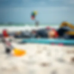 Variety of kitesurfing equipment laid out on the beach