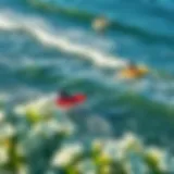 An aerial view of surfers catching waves at a popular California beach