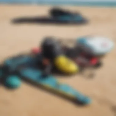 A close-up of kiteboarding gear laid out on the sandy beach