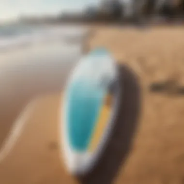 A close-up of a surfboard resting on the sandy beach