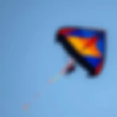 An aerial shot of the Slingshot Trainer Kite soaring against a clear blue sky.