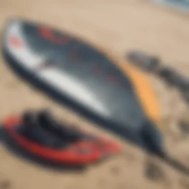 Close-up of essential kite surfing equipment laid out on the beach