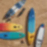 A variety of kiteboards displayed on a sandy beach