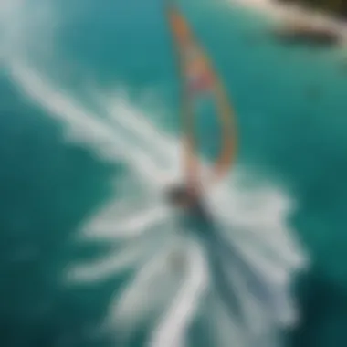 An aerial view of a sailboat surrounded by kiteboarders enjoying the wind