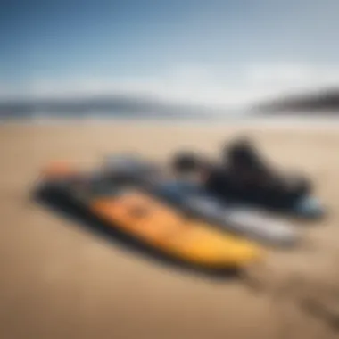 Kiteboarding gear laid out on the sandy shore